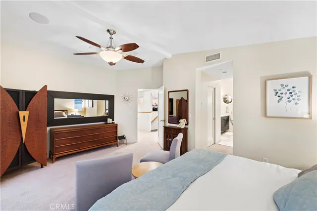 a bedroom with furniture and a ceiling fan