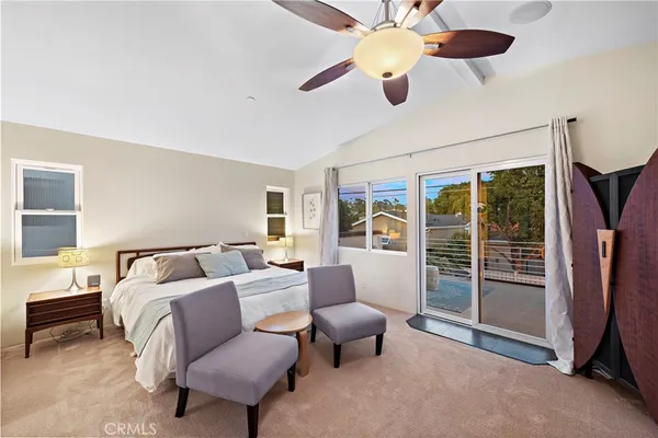 a living room with furniture ceiling fan and a window