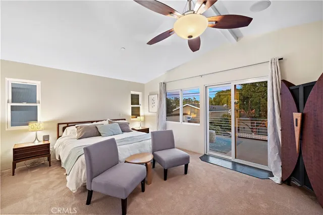 a living room with furniture ceiling fan and a window