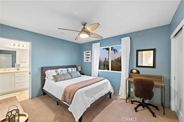 a bedroom with a bed and a desk