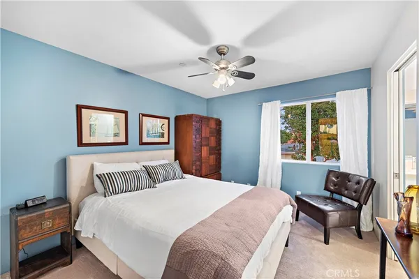 a bedroom with a large bed and a window