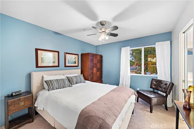 a bedroom with a large bed and a window