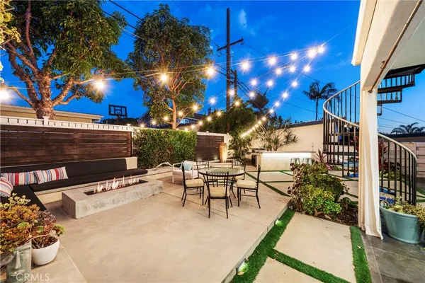 a view of a patio with couches table and chairs and potted plants