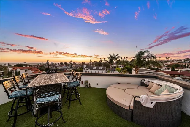 a terrace with outdoor seating and city view