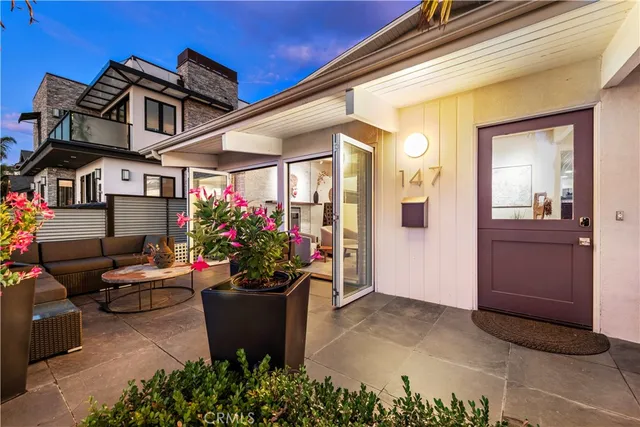 a view of a porch with furniture and flowers