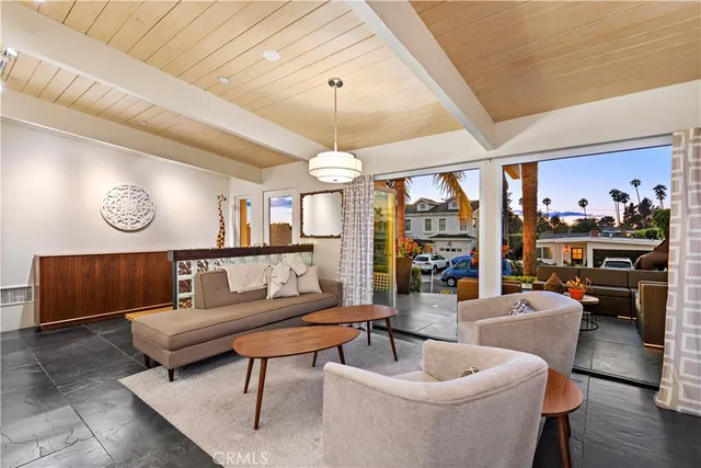 a living room with furniture a wooden floor and a chandelier