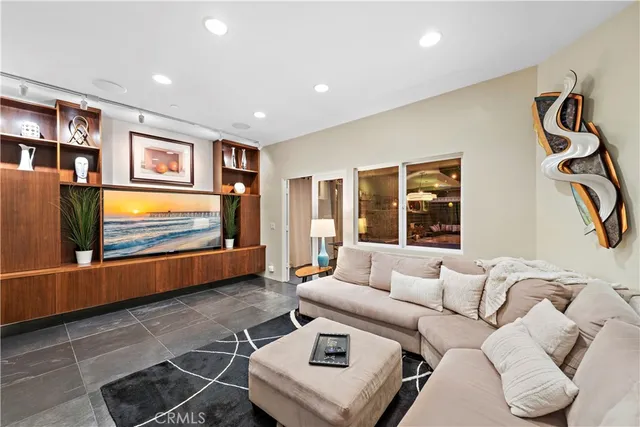 a living room with furniture and a wall painting