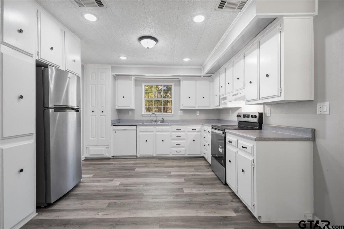 18607-c R 498 C R 498 Lindale, TX 75771 - Photo 8 of 41 a kitchen with white cabinets and stainless steel appliances