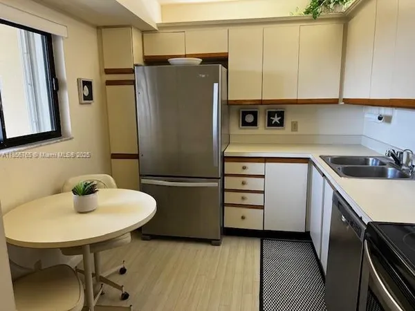 a kitchen with stainless steel appliances a refrigerator and a sink