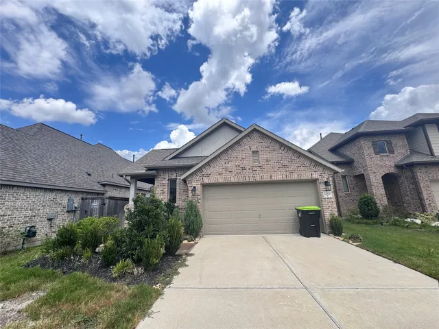 a front view of house with yard and trees