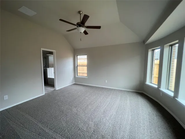 a view of room with a ceiling fan and window