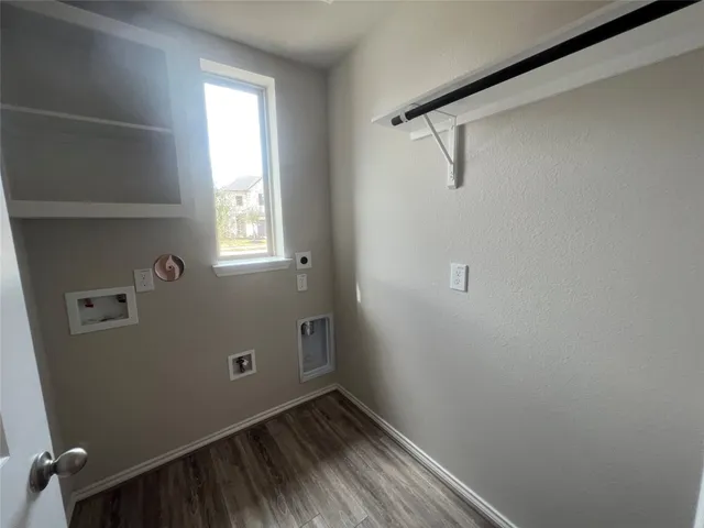 a view of a room with rack on the wall and a window