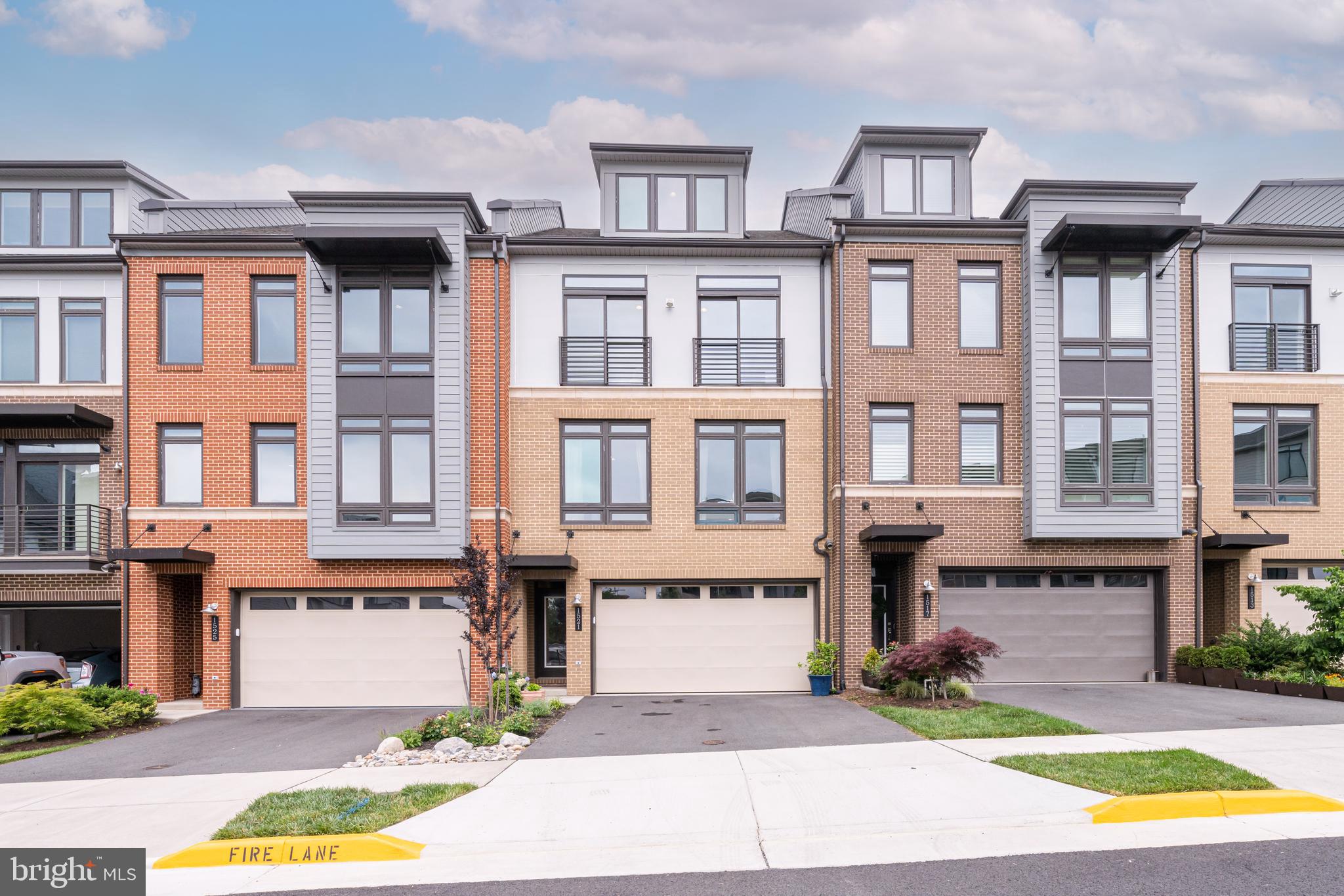 1521 Ribbon Limestone Terrace Southeast Leesburg, VA 20175 - Photo 1 of 34 a front view of a residential apartment building with a yard and entryway