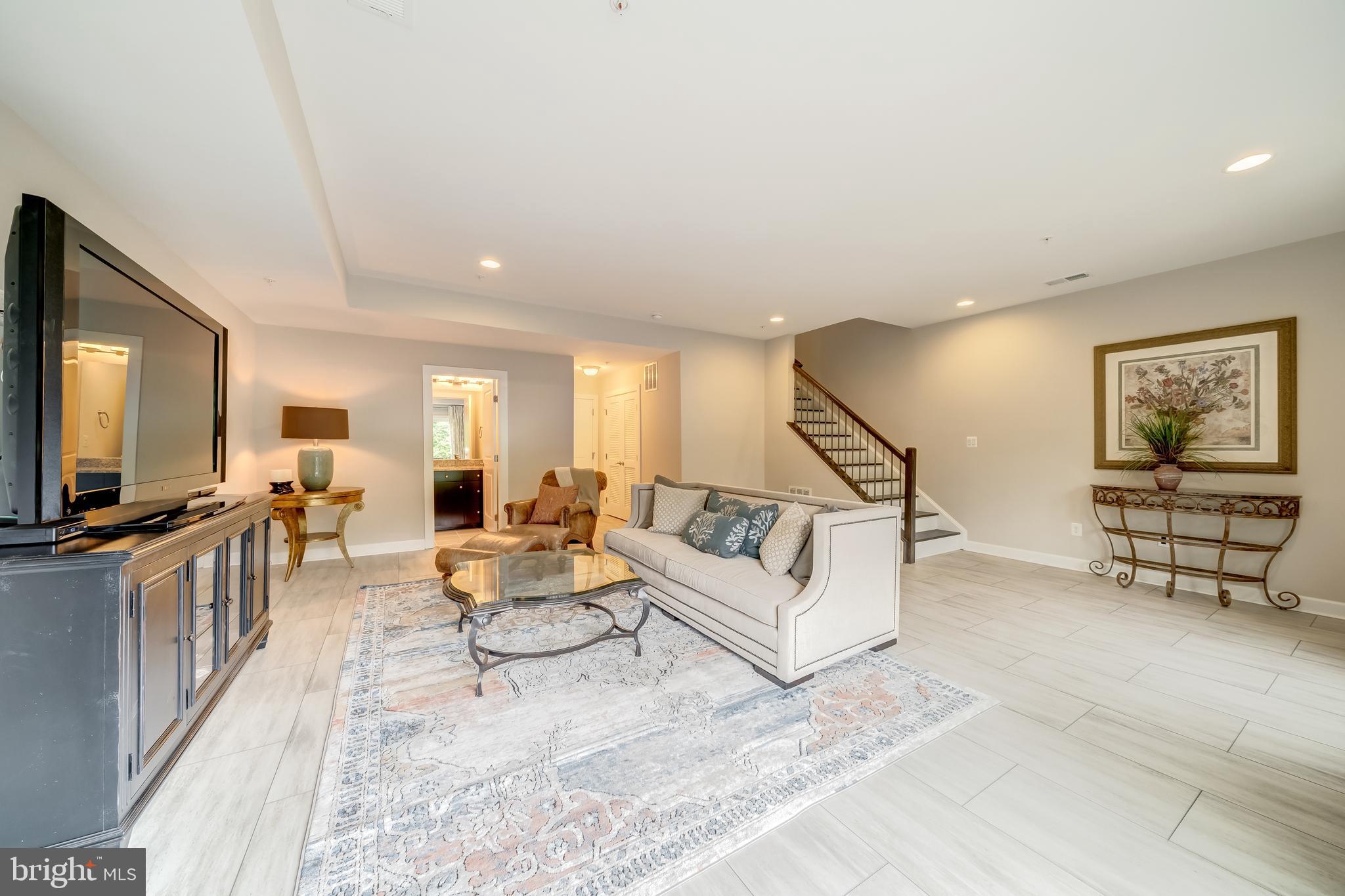 1521 Ribbon Limestone Terrace Southeast Leesburg, VA 20175 - Photo 12 of 34 a living room with furniture and a flat screen tv