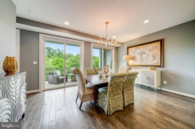a dining room with furniture window and wooden floor