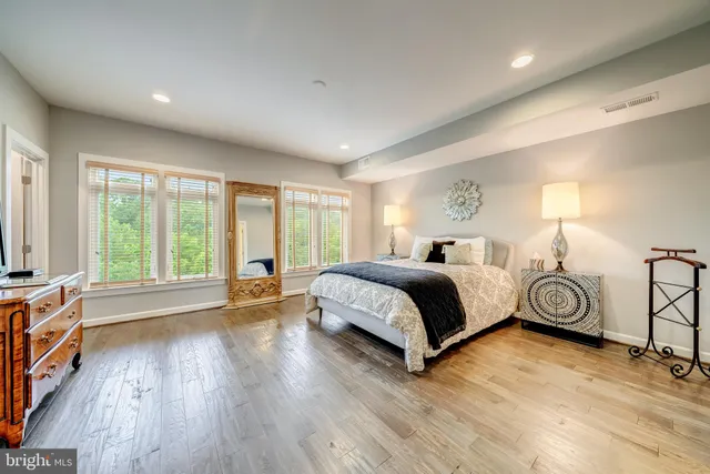 a bedroom with a bed and a large window