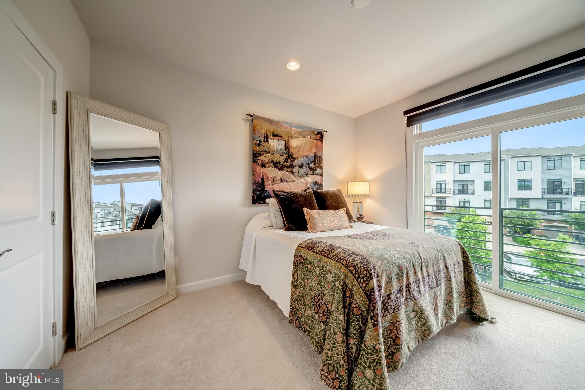 1521 Ribbon Limestone Terrace Southeast Leesburg, VA 20175 - Photo 26 of 34 a spacious bedroom with a bed and large window