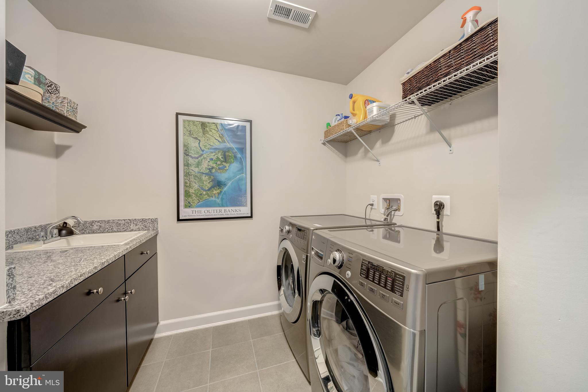 1521 Ribbon Limestone Terrace Southeast Leesburg, VA 20175 - Photo 29 of 34 a utility room with a sink dryer and washer