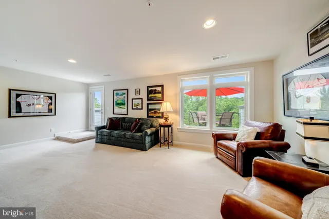 a spacious bedroom with a bed and ceiling fan