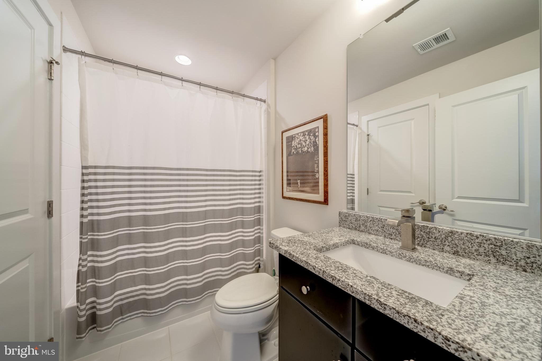 1521 Ribbon Limestone Terrace Southeast Leesburg, VA 20175 - Photo 34 of 34 a bathroom with a granite countertop sink toilet and shower