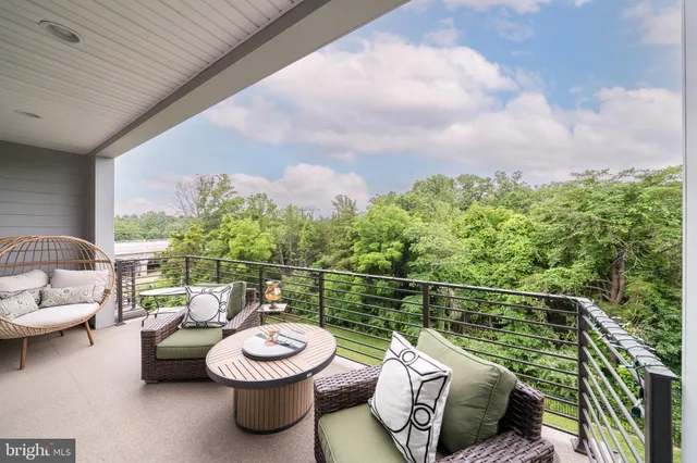 a view of a roof deck with a table and chairs