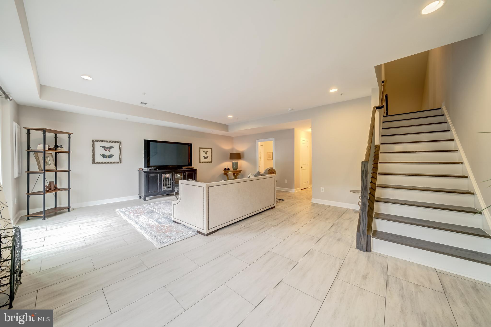 1521 Ribbon Limestone Terrace Southeast Leesburg, VA 20175 - Photo 10 of 34 a living room with furniture and a flat screen tv