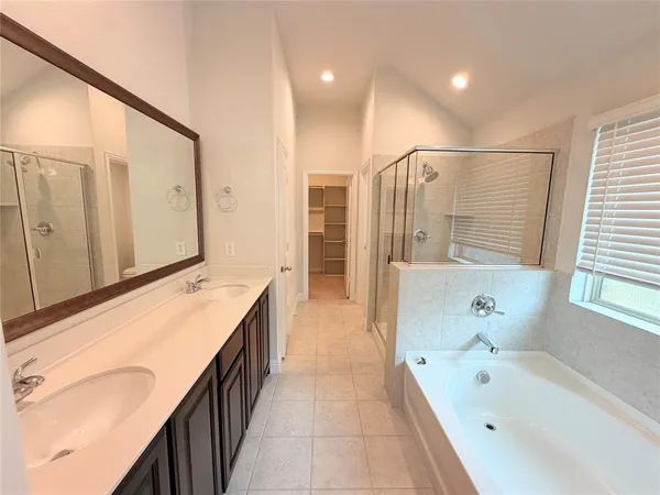 a large kitchen with stainless steel appliances granite countertop a stove and a sink with cabinets