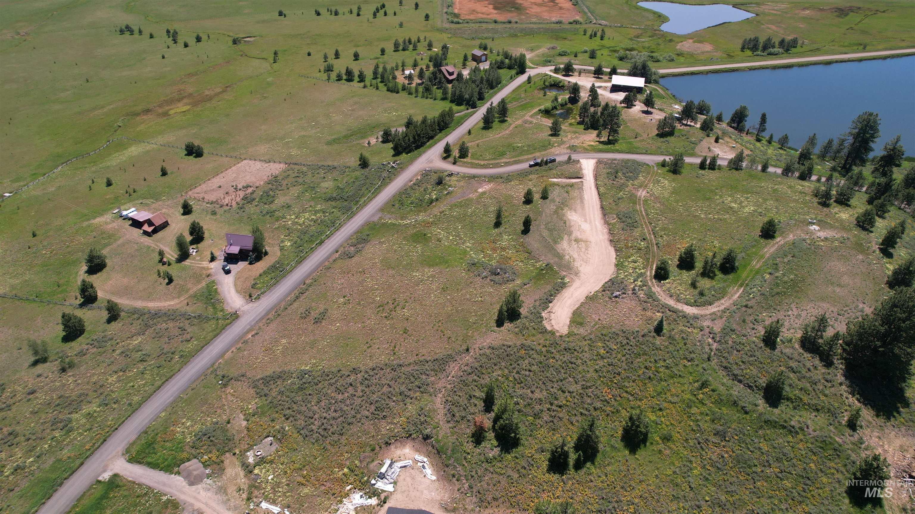 Lot 7 Wilderness Ranch Lane Cascade, ID 83611 - Photo 9 of 46 Aerial view of property and surrounding area with a large body of water and rural landscape