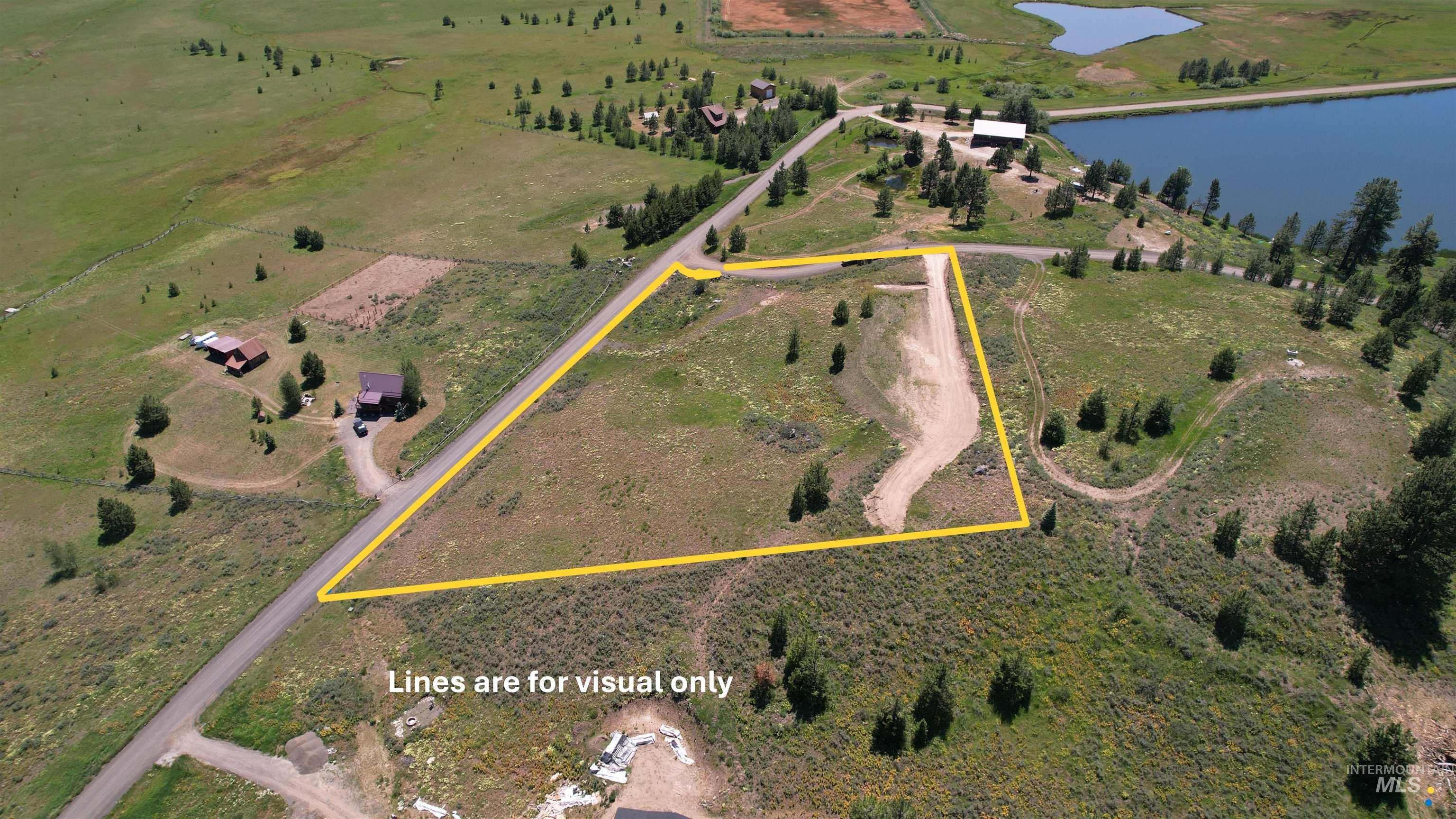 Lot 7 Wilderness Ranch Lane Cascade, ID 83611 - Photo 10 of 46 Aerial view of sparsely populated area featuring a nearby body of water and property parcel outlined