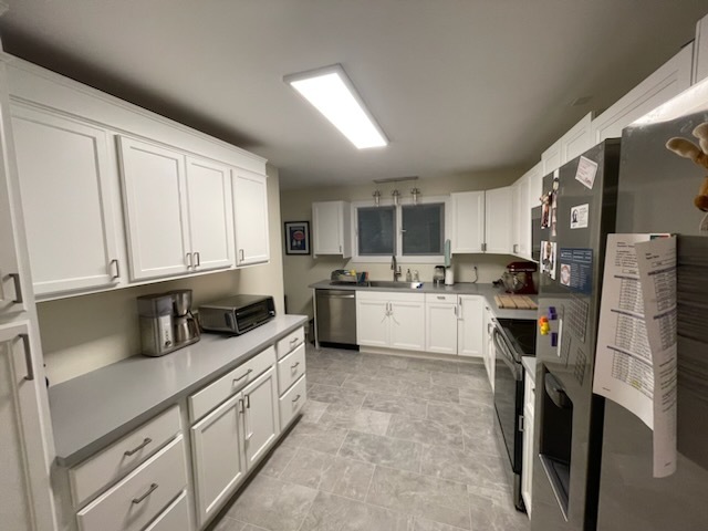 1008 Broadmoor Drive Champaign, IL 61821 - Photo 6 of 8 a kitchen with white cabinets and white appliances