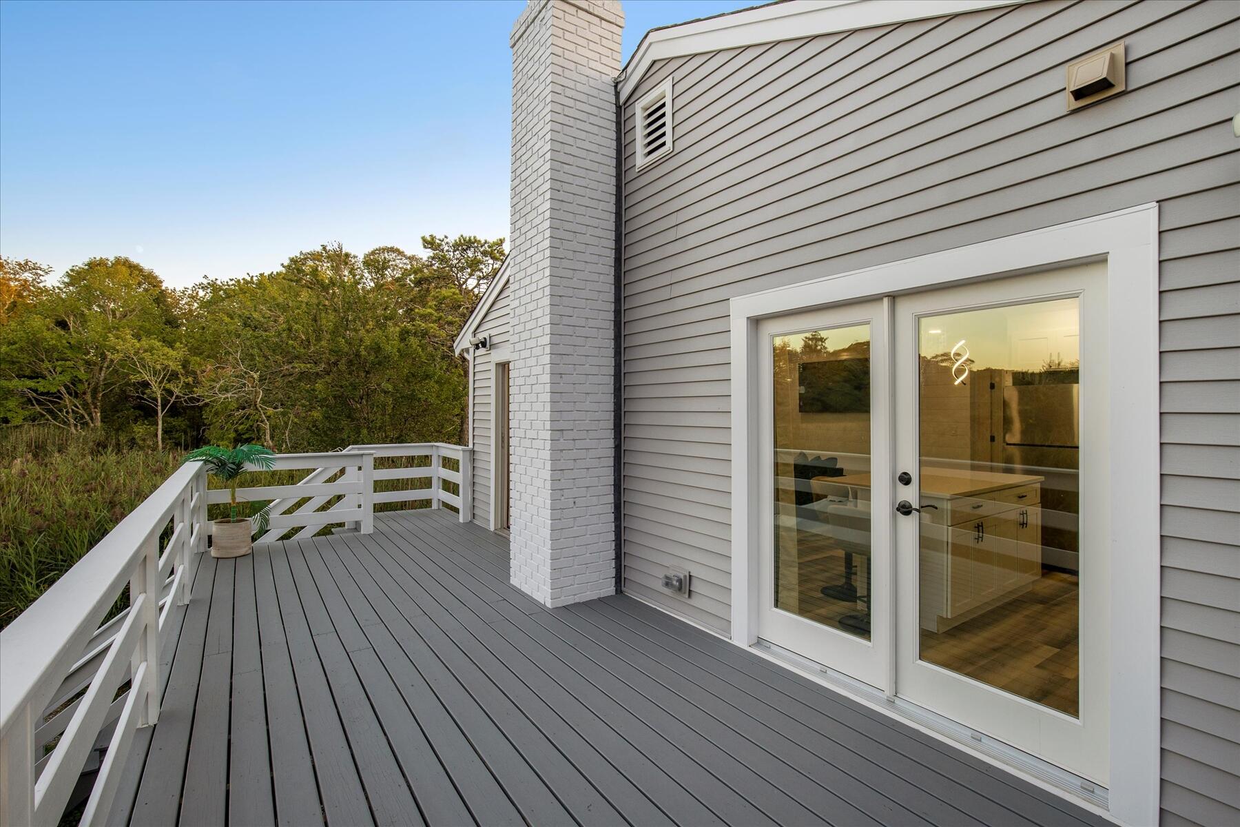 65 Marsh Lane Hyannis, MA 02601 - Photo 19 of 22 a view of a patio with a table and chairs