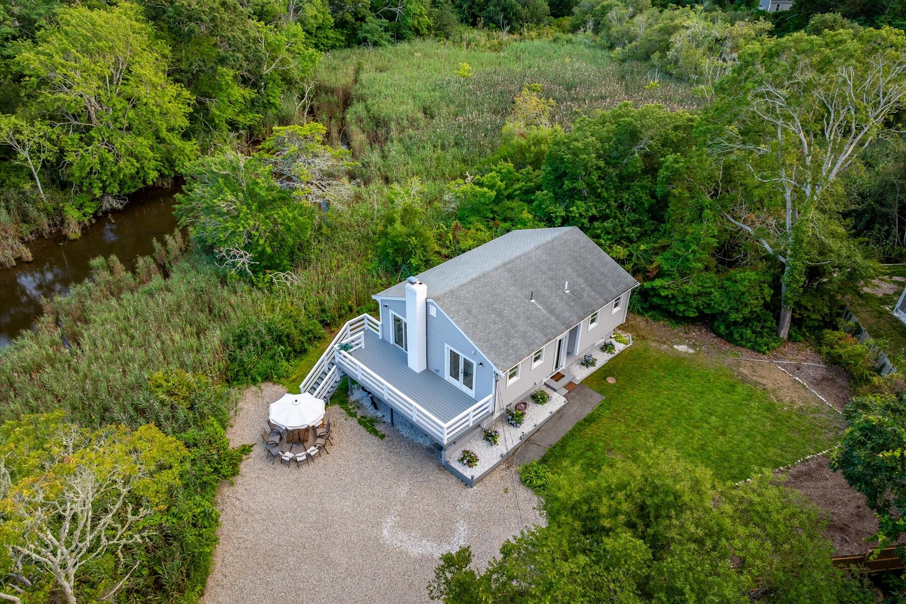 65 Marsh Lane Hyannis, MA 02601 - Photo 21 of 22 a view of a house with a yard and sitting area