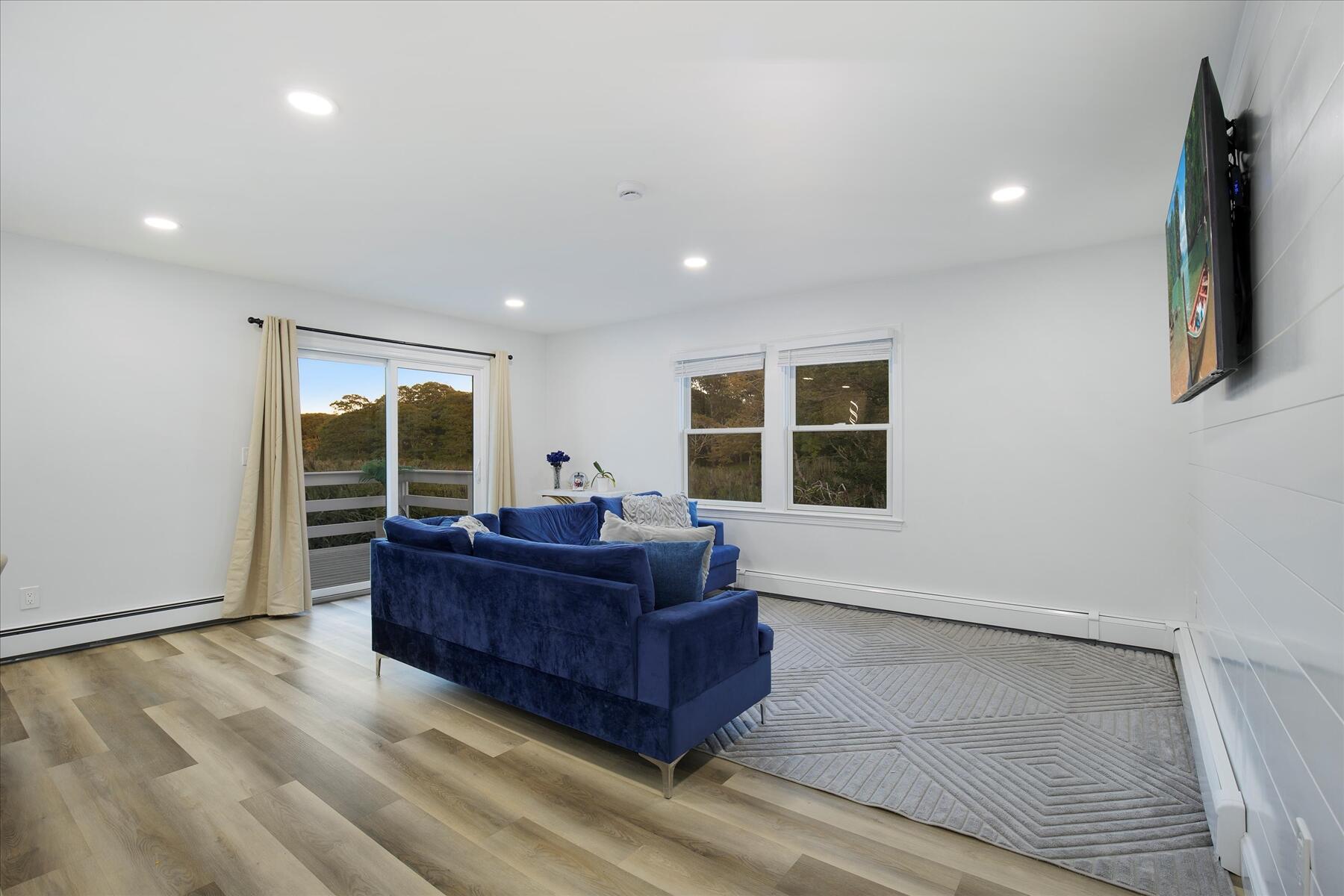 65 Marsh Lane Hyannis, MA 02601 - Photo 4 of 22 a living room with hard wood floors and a bed