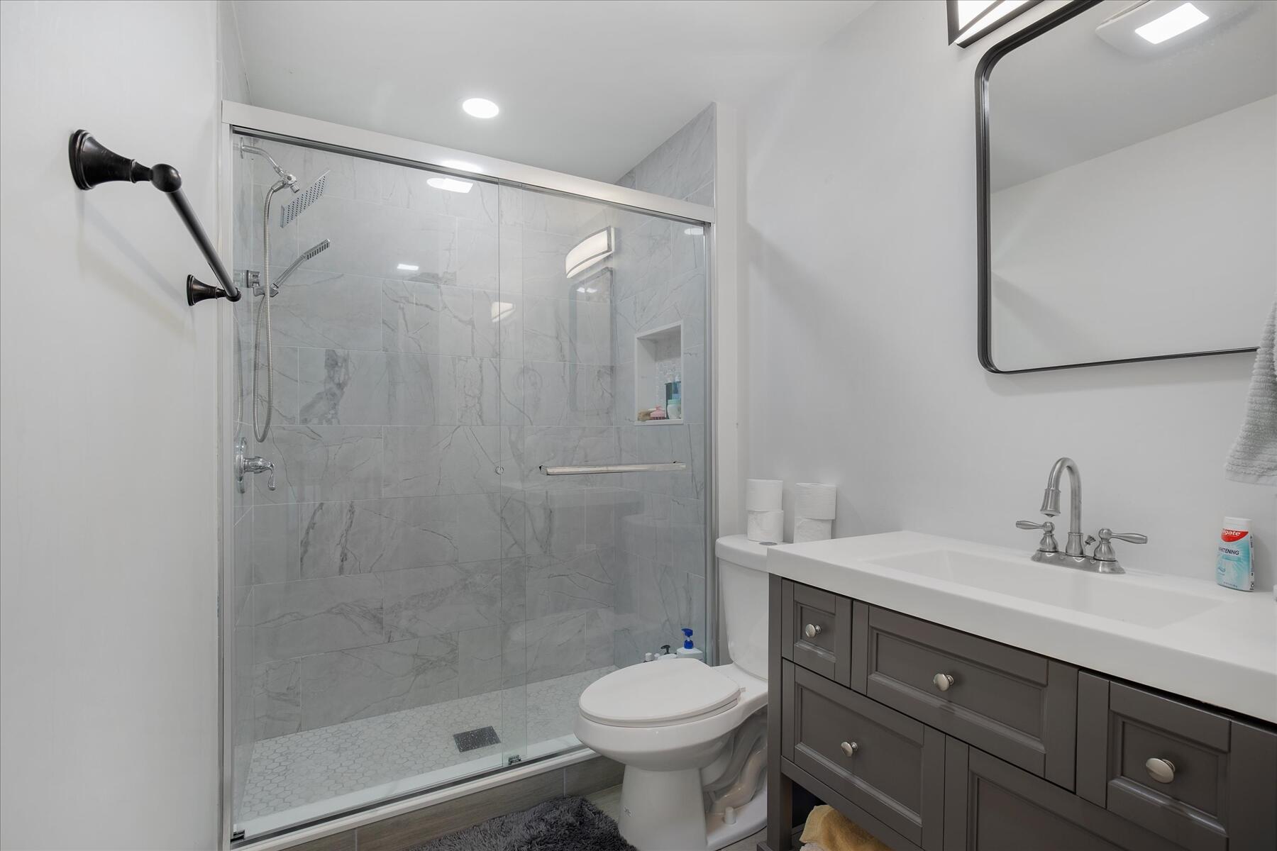 65 Marsh Lane Hyannis, MA 02601 - Photo 7 of 22 a bathroom with a shower sink vanity and toilet