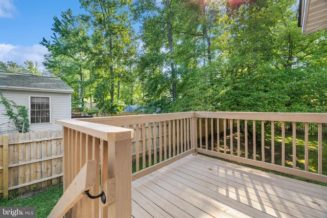 a balcony with wooden floor and fence