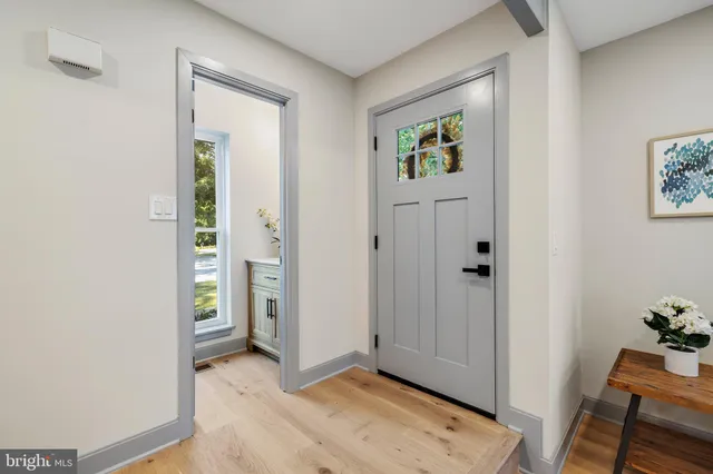 a view of an entryway with wooden floor