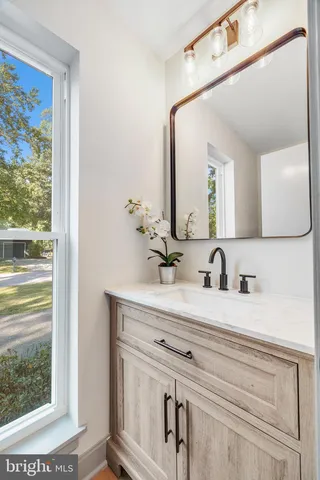 a bathroom with a sink vanity and a mirror
