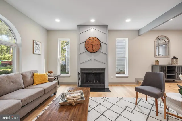 a living room with furniture a fireplace and window
