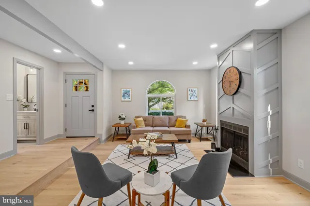 a living room with fireplace furniture and a fireplace