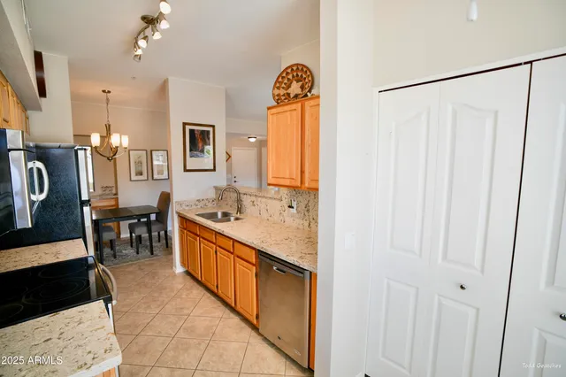 a kitchen with stainless steel appliances granite countertop a stove a refrigerator and a microwave