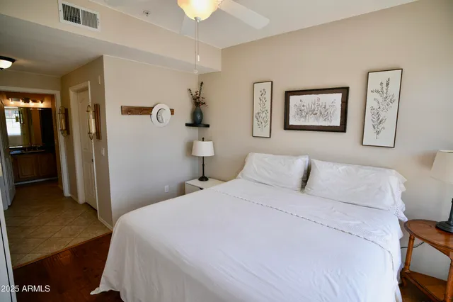 a bedroom with a bed and a chandelier