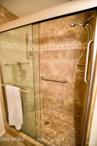 a bathroom with a granite countertop toilet sink and mirror