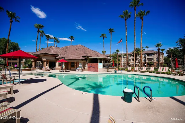 a view of a tables and chairs under an umbrella