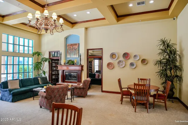 a view of a room that has a table and a chair in it