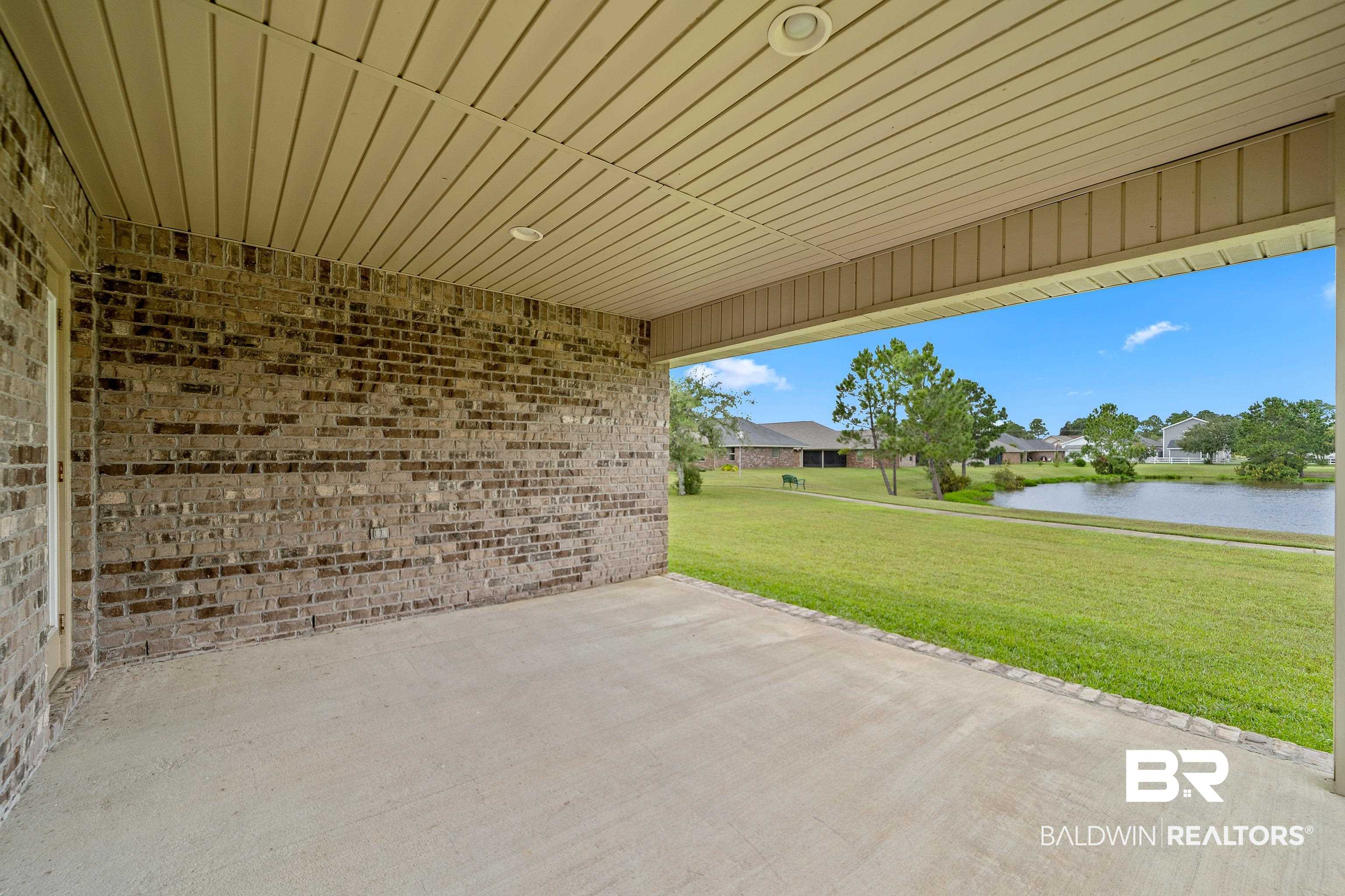 22631 Lake South Drive Foley, AL 36535 - Photo 20 of 25 View of patio / terrace with a water view