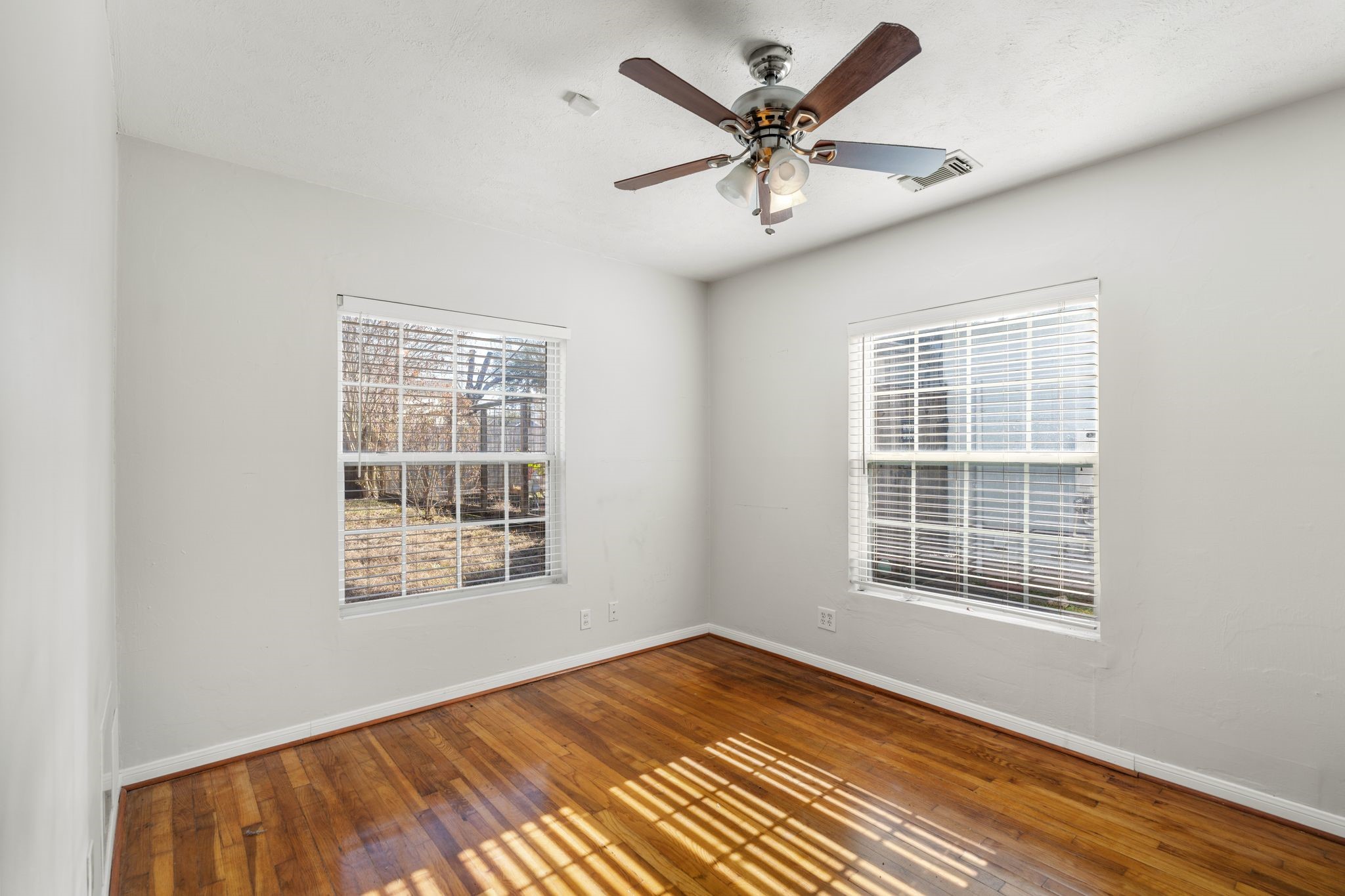 1811 West 14th 1/2 Street Houston, TX 77008 - Photo 19 of 25 a view of an empty room with a window and wooden floor