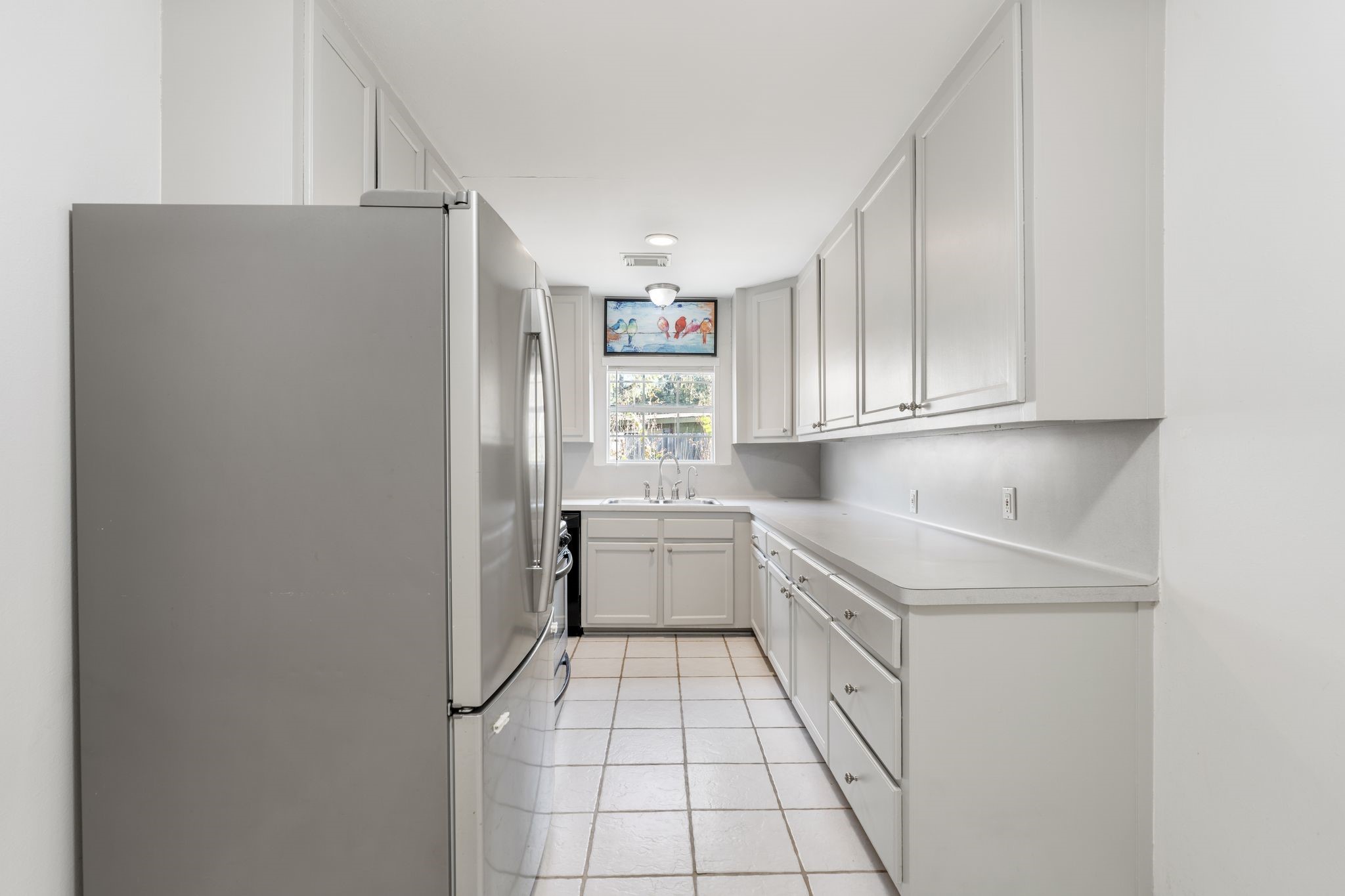 1811 West 14th 1/2 Street Houston, TX 77008 - Photo 9 of 25 a kitchen with stainless steel appliances a refrigerator and sink