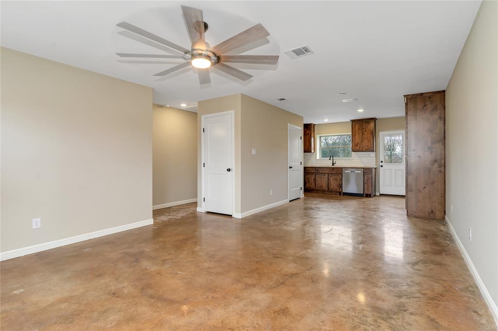 1371 Cr-704a, Unit 3 Joshua, TX 76058 - Photo 1 of 20 Unfurnished living room with sink, concrete flooring, and ceiling fan