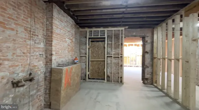 a view of a hallway with brick walls