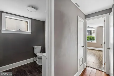 a white toilet sitting next to a bathroom sink